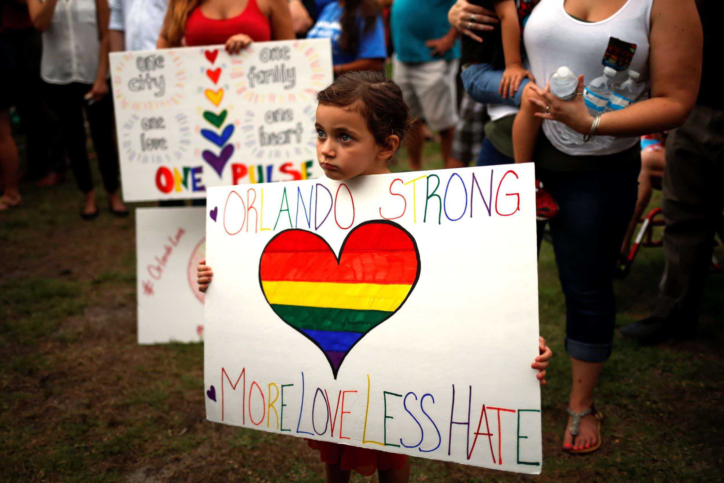 Girl holding sign reading: Orland Strong; More Love, Less Hate